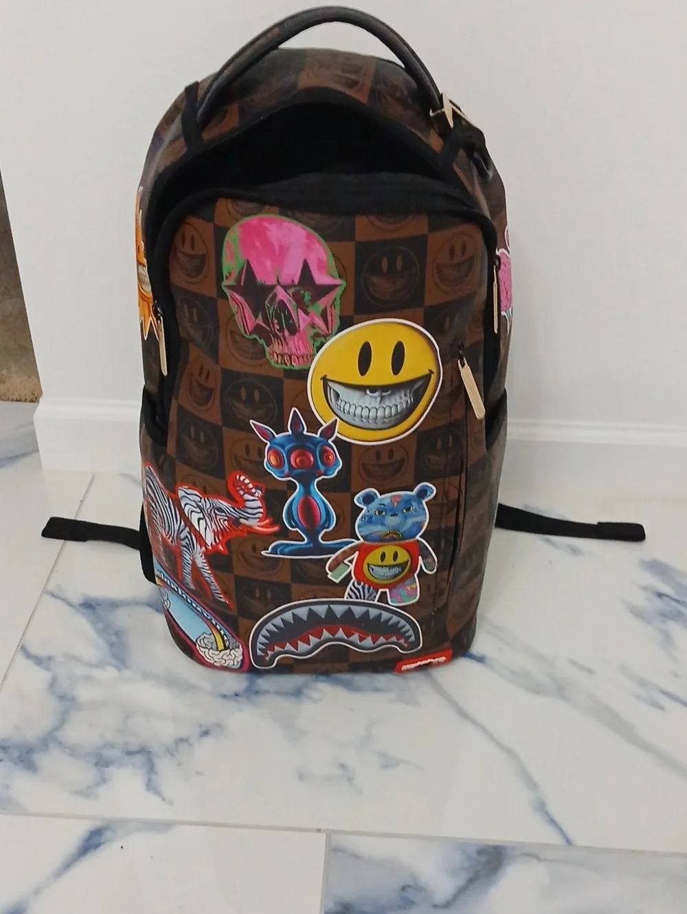 Sprayground Brown Checkerboard Backpack with Multicolor Sticker Graphics